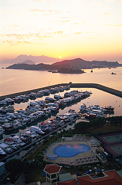 Sunrise over Peng Chau Island with Discovery Bay Marina in foreground, Hong Kong, China, Asia