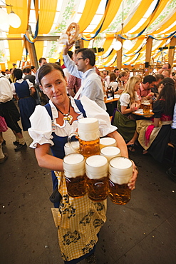 Waitress with beer steins, Oktoberfest, Munich, Bavaria, Germany, Europe