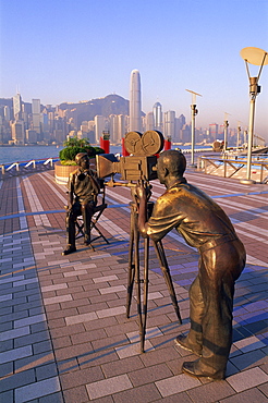 The Producers statue with city skyline in the background, Avenue of the Stars, Tsim Sha Tsui, Kowloon, Hong Kong, China, Asia