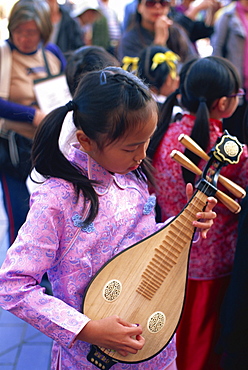 Girl playing Chinese mandolin, Tsim Sha Tsui, Kowloon, Hong Kong, China, Asia