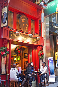 Chinese office girls drinking in bar, Lan Kwai Fong, Central, Hong Kong, China, Asia