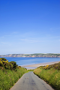 Empty road and beach, Pembrokeshire Coast National Park, Pembrokeshire, Wales, United Kingdom, Europe