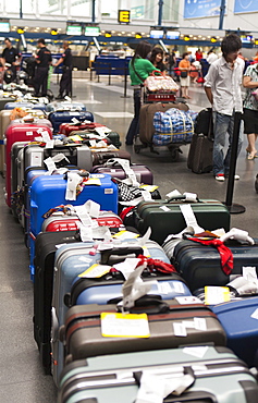 Airline passengers and luggage line up on the floor at the Beijing Capital Airport, Beijing, China, Asia