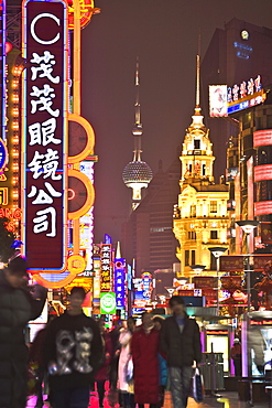 Neon lit night scene of the main shopping district along Nanjing Road, Shanghai, China, Asia