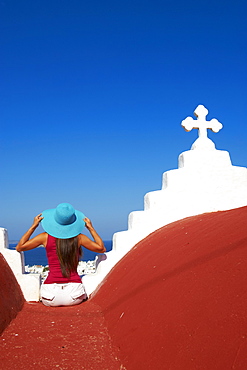 Tourist on roof of red church above the old town, Mykonos town, Chora, Mykonos, Cyclades, Greek Islands, Greece, Europe