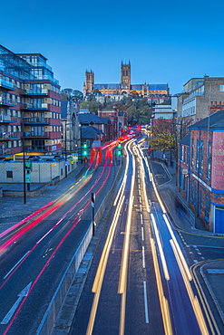 View of Lincoln Cathedral and traffic on Broadgate at dusk, Lincoln, Lincolnshire, England, United Kingdom, Europe