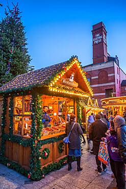 View of visitors and Christmas Market stalls at Christmas Market, Millennium Square, Leeds, Yorkshire, England, United Kingdom, Europe