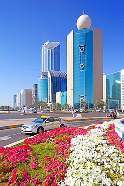 Contemporary architecture and taxi on Rashid Bin Saeed Al Maktoum Street, Abu Dhabi, United Arab Emirates, Middle East