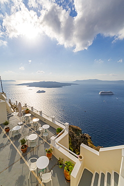 View of Fira restaurant and cruise ship, Firostefani, Santorini (Thira), Cyclades Islands, Greek Islands, Greece, Europe