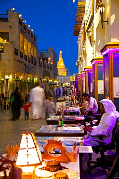 Souq Waqif looking towards the illuminated spiral mosque of the Kassem Darwish Fakhroo Islamic Centre, Doha, Qatar, Middle East