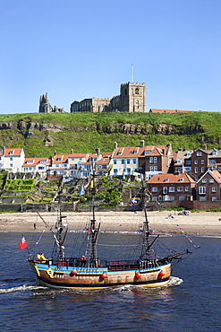 Pleasure ship below Whitby Abbey and St. Marys Church, Whitby, North Yorkshire, Yorkshire, England, United Kingdom, Europe