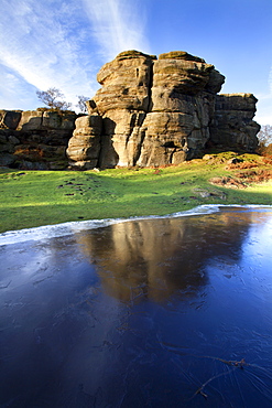 Gritstone formations at Brimham Rocks reflected in frozen flood water, Summerbridge, North Yorkshire, Yorkshire, England, United Kingdom, Europe