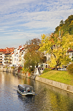 River cruise boat on the Ljubljanica River in autumn, Ljubljana, Slovenia, Europe