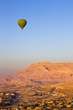 Hot air balloon suspended over the Theban hills of Luxor, Egypt, North Africa, Africa