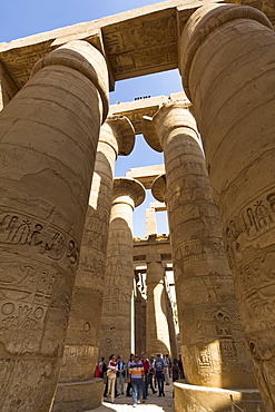 Tourists dwarfed by the towering columns of the Great Hypostyle Hall of the Karnak Temple of Amun, Thebes, UNESCO World Heritage Site, Egypt, North Africa, Africa