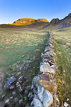 Drystone wall beneath Attermire Scar at sunrise, Settle, North Yorkshire, Yorkshire, England, United Kingdom, Europe