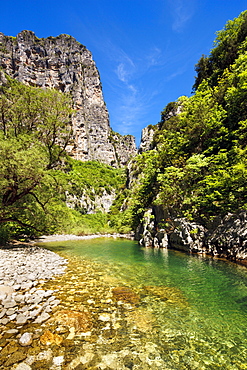 The clear waters of the Voidomatis River in the Vikos Gorge in spring, Zagoria, Epirus, Greece, Europe