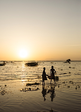 Children of the Dassanech tribe fishing on the shore of Turkana Lake, Omo Valley, Ethiopia, Africa