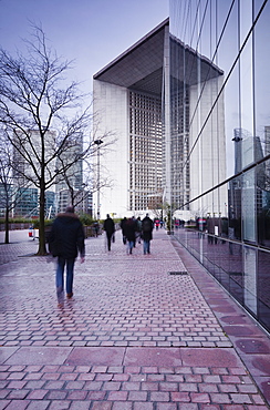 Commuters leaving work in the La Defense area with La Grande Arche in the background, Paris, France, Europe 