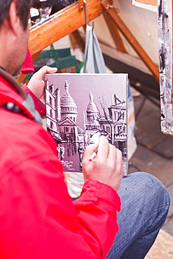 A street artist at work in the famous Place du Tertre in Montmartre, Paris, France, Europe