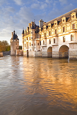 The River Cher and Chateau Chenonceau lit up by the setting sun, Indre-et-Loire, Centre, France, Europe