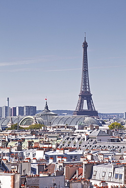 The Eiffel Tower rising over the rooftops of Paris, France, Europe