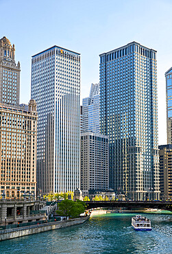 Downtown skyline and river cruise boat on the Chicago River near the Michigan Avenue Bridge, Chicago, Illinois, United States of America, North America