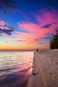 Couple walk at sunset on the beach of l'Ermitage, La Reunion Marine Nature Reserve, Indian Ocean