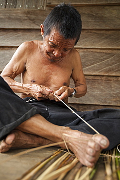 Man weaving a traditional fish basket - Borneo Indonesia