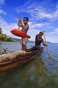 Fisherman on canoe Fergusson island Papua New Guinea