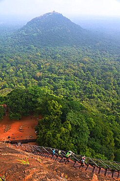 Tourists on the staircase going to the summit of the Lion's rock, former capitale of king Kasyapa from 477 to 495. Sirigiya. Sri-Lanka.