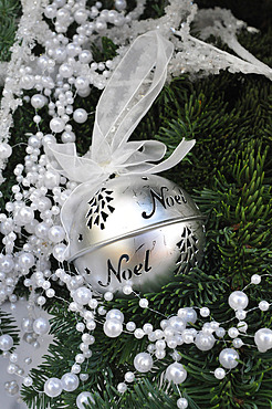 Christmas ball with ribbon, festive decoration, tree and pearl garland