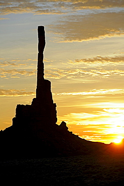 sunrise over landscape with rock formation Totem Pole in Monument Valley silhouette mood