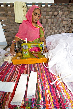 Disabled women swing garments at the Barefoot College in Tilonia, Rajasthan, India. The Barefoot College is a worldwide charity, founded by Bunker Roy, its aims are, education, drinking water, electrification through solar power, skill development, health, women empowerment and the upliftment of rural people.