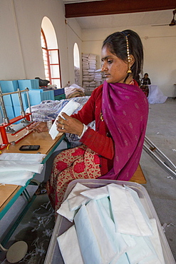 A disabled women making nappies at the Barefoot College in Tilonia, Rajasthan, India. The Barefoot College is a worldwide charity, founded by Bunker Roy, its aims are, education, drinking water, electrification through solar power, skill development, health, women empowerment and the upliftment of rural people.