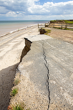 A collapsed coastal road at Easingotn on Yorkshires East Coast, near Skipsea, UK. The coast is composed of soft boulder clays, very vulnerable to coastal erosion. This sectiion of coast has been eroding since Roman times, with many villages having disappeared into the sea, and is the fastest eroding coast in Europe. Climate change is speeding up the erosion, with sea level rise, increased stormy weather and increased heavy rainfall events, all palying their part.