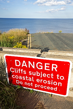 A collapsed coastal road near Skipsea on Yorkshires East Coast, UK. The coast is composed of soft boulder clays, very vulnerable to coastal erosion. This sectiion of coast has been eroding since Roman times, with many villages having disappeared into the sea, and is the fastest eroding coast in Europe. Climate change is speeding up the erosion, with sea level rise, increased stormy weather and increased heavy rainfall events, all playing their part.