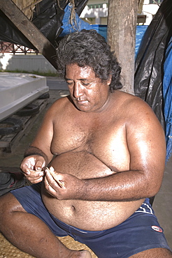 A Tuvaluan man making home made cigarettes on Funafuti Atoll, Tuvalu, Pacific