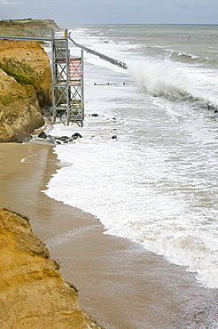 Waves crashing against sea defences at Happisburgh on the fastest eroding section of the UK coast, Norfolk, England, United Kingdom, Europe