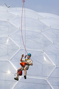 A tourist on a zip wire at the Eden Project, Cornwall, England, United Kingdom, Europe