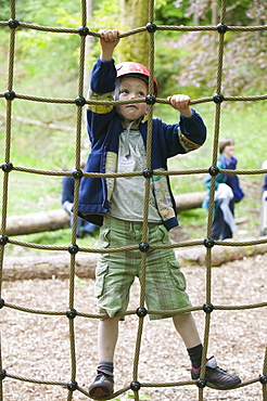 A young boy on a ropes course at Brathay in the Lake District, Cumbria, England, United Kingdom, Europe