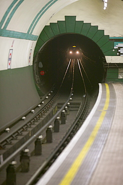 A train coming out of a tunnel at an underground station, London, England, United Kingdom, Europe