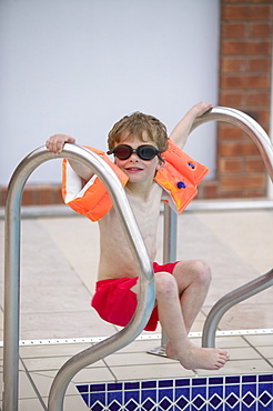 A young boy in an indoor swimming pool, England, United Kingdom, Europe