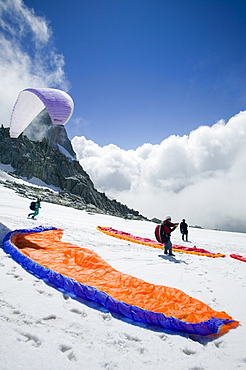 Paraponters preparing to take off from the Grand Montets above Chamonix, Haute Savoie, France, Europe