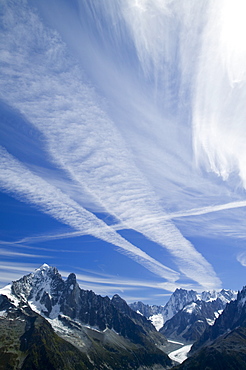 Airplane vapour trails over the Mer du Glace, Chamonix, Haute Savoie, France, Europe