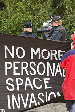 A police photographer photographing protestors at the Climate Camp protest against airport development at Heathrow and the village of Sipson that would be demolished to make way for a third runway, Greater London, England, United Kingdom, Europe