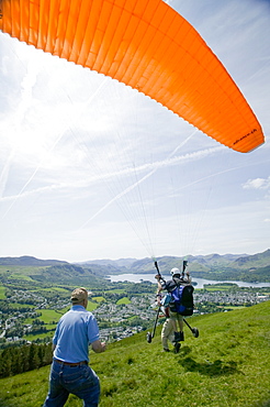 A wheelchair bound disabled person preparing to go parapont flying above Keswick, Lake District, Cumbria, England, United Kingdom, Europe