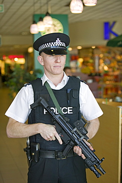 An armed police officer at Birmingham Airport, England, United Kingdom, Europe