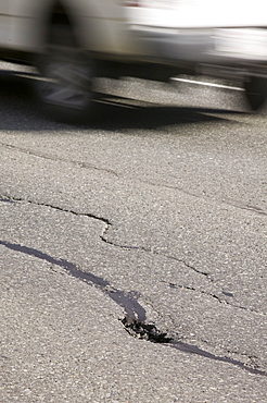 Cracks in an Alaskan road caused by the underlying permafrost melting due to global warming, United States of America, North America