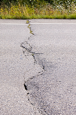 A road in Fairbanks collapsing into the ground due to global warming induced permafrost melt, Alaska, United States of America, North America